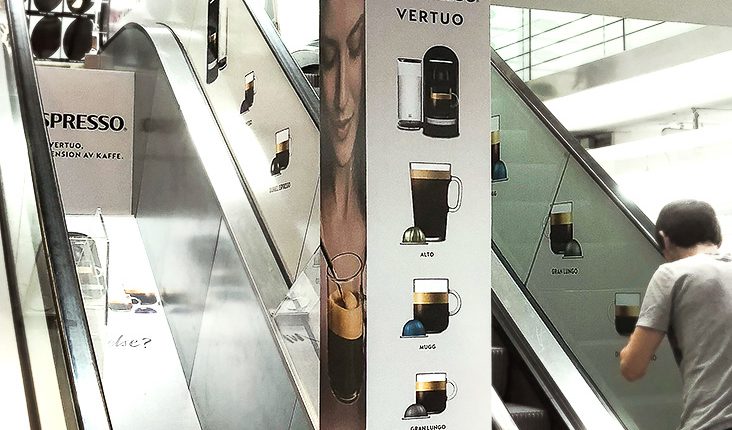 Skyltning av rulltrappor och stolpar till Nespresso Vertuo